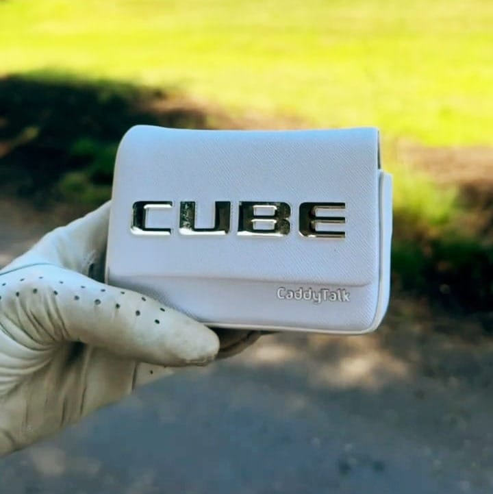 A golf-gloved hand holding the CUBE's dedicated pouch.