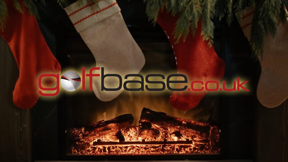 Christmas stockings above a fire with the Golfbase logo imposed in front